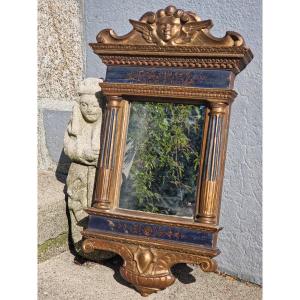 Italian Mirror In Gilded And Polychrome Painted Wood In The Shape Of A Temple And Decorated With A Cherub 