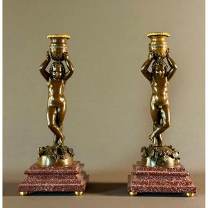 A Pair Of Patinated Bronze Candlesticks With Putti Depicted As Canephores. Circa 1850