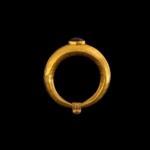 A Roman Gold And Garnet Cabochon Ring.