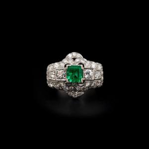 A Diamond And Platinum Ring, Set With A Rectangular Shaped Emerald