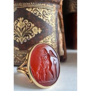 A Neoclassical Gold Ring Set With A Carnelian Intaglio. Eros With A Dog.
