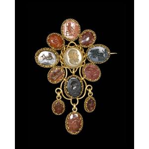 Victorian Gold Brooch Set With Twelve Intaglios On Hard Stones. Various Subjects.