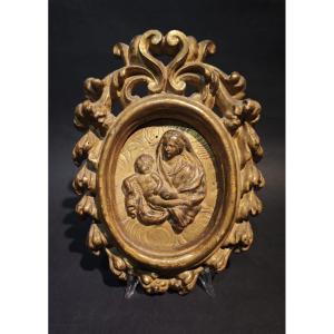 Bassorilievo raffigurante Madonna col Bambino entro cornice intagliata e dorata, inizi XVIII se