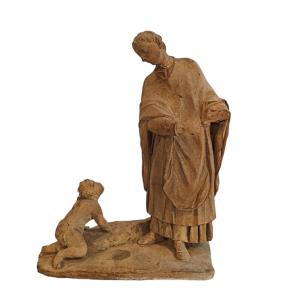 Scultura in terracotta raffigurante uomo con bambino. Italia, inizio XVIII secolo.