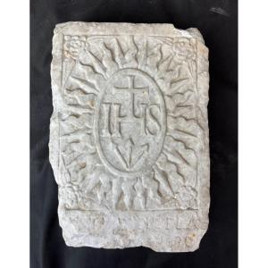 Formella datata 1630 con scolpito il trigramma di San Bernardino da Siena