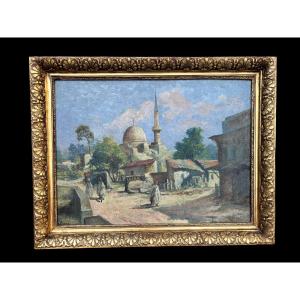 Dipinto raffigurante un paesaggio orientale, firmato in basso a sinistra
