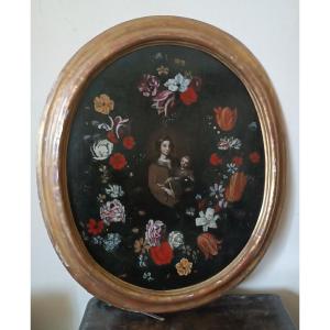 Dipinto olio su tela ,scuola italiana,Madonna con bambino su ghirlanda di fiori-XVII secolo