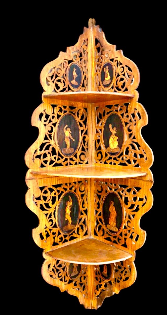 Applique angolare Etagere in legno traforato a tre ripiani con medaglioni con scene popolari.