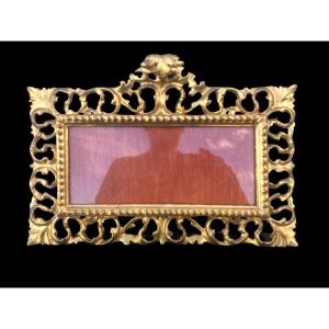 Cornice rettangolare a cartoccio in legno intagliato,traforato e foglia oro.Firenze.