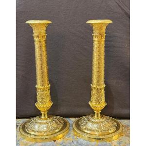 Pair Of Restoration Period Candlesticks In Chiseled And Gilded Bronze.