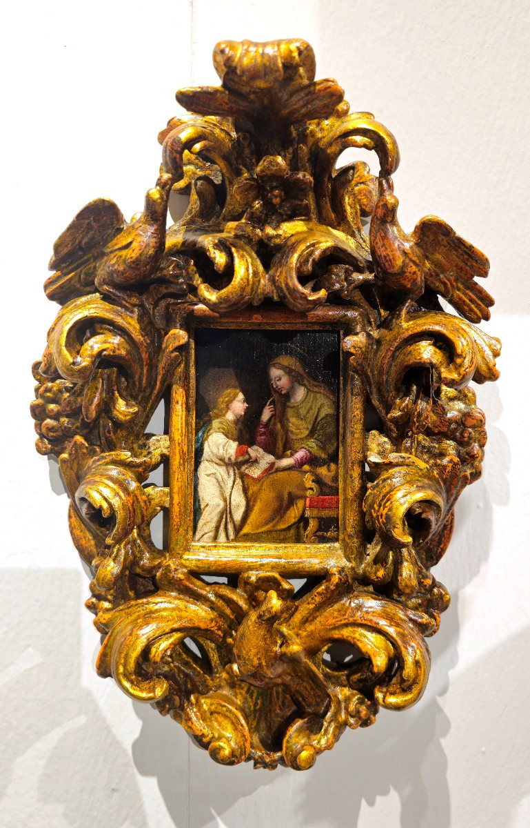 Dipinto su tavoletta entro cornice coeva raffigurante "Sant'Anna che educa la Vergine Maria"