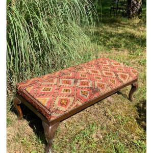 English Bench Covered With An Oriental Rug