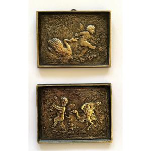 Pair Of Small Bronze Bas-reliefs. 19th. Angelots Pursued By A Swan And A Stilt-walker.