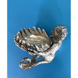 Salt Cellar In Silver Plated Metal. Seated Monkey Holding A Shell.