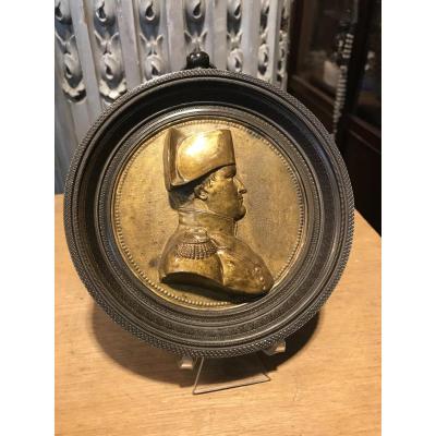 Golden Metal Medallion Figuring The Profile Of The Emperor.