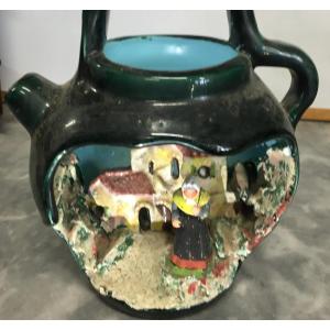 Creche In A Dark Green Jug