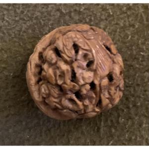 Carved Nut Decorated With An Asian Figure 