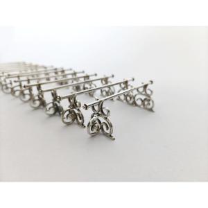 Neo Renaissance: Twelve Solid Silver Knife Rests With Scroll Decoration. 