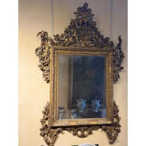 Importante specchiera Luigi XIV in legno intagliato e dorato, Venezia, fine XVII secolo