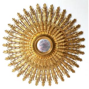 Imponete specchiera in legno dorato a forma di sole