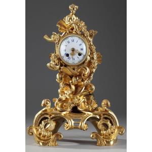 Rocaille Style Clock In Gilded Bronze, Decorated With A Cupid In A Shell