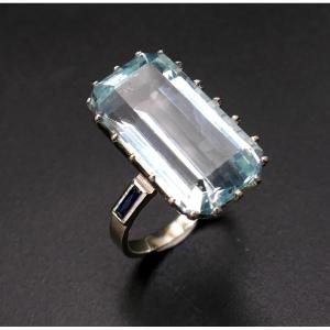 Ring Set With An Aquamarine Shouldered By Calibrated Sapphires.
