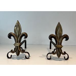 Pair Of Bronze And Wrought Iron Andirons Representing A Fleurs De Lys. French Work. Towards