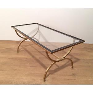Rectangular Brass Coffee Table With Clear Glass Top Surrounded With Black Lacquered Edges.