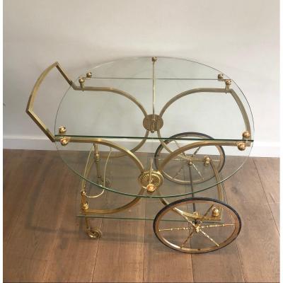 Maison Bagués. Rare Neoclassical Style Brass And Glass Drinks Trolley With Folding Rounded Glass Sides. French. Circa 1940