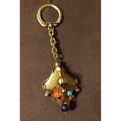 PORTE CLEF en or jaune avec breloque