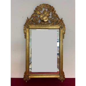 Specchiera in legno intagliato e dorato a foglia. Toscana epoca impero prima metà 800
