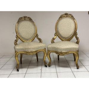 Coppia di poltrone in legno intagliato e dorato. XIX secolo