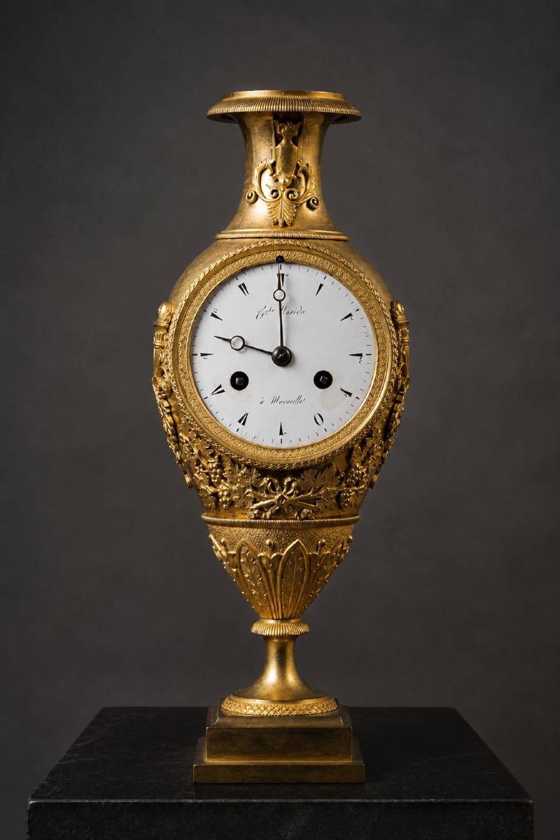 Pendola in bronzo dorato decorato con foglie e tralci di vite. Impero, XIX secolo