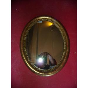 Small Oval Mirror From The 19th Century, In Gilded Wood.