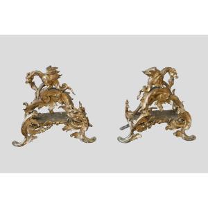 Large Pair Of Gilt Bronze Andirons Depicting Griffins Dating From The 19th Century.