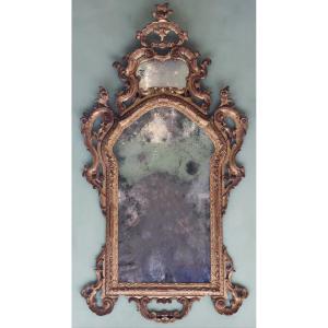 Specchiera in legno intagliato, scolpito e dorato. Venezia, metà XVIII secolo