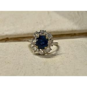 Marguerite Ring In White And Yellow Gold, Oval Sapphire Of 1.60 Carats And Diamonds Totaling 1.20 Carats