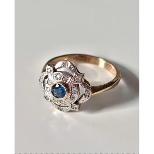Gold Ring Set With A Central Sapphire And 16 Diamonds