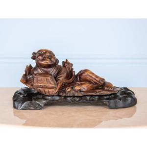 The Laughing Buddha, A Reclining Figure Carved In Hardwood From The Meiji Period.