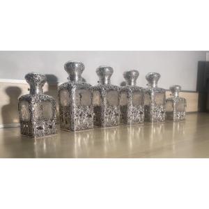 A Series Of Crystal And Sterling Silver Perfume Bottles