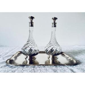 Pair Of Footed Liqueur Decanters With Silver Handles And Mounts On A Silver-plated Metal Tray