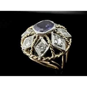 Two-tone Gold Ring Set With An Amethyst In The Center Surrounded By Diamonds