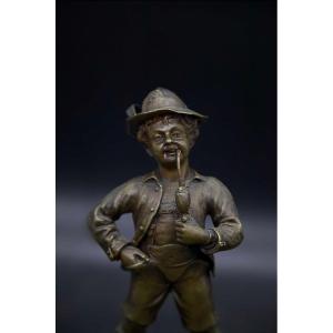 Small Chiseled Bronze Young Man Smoking A Pipe