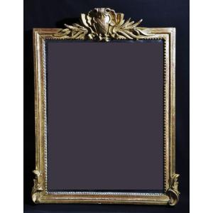 Louis XVI Period Mirror In Carved And Gilded Wood, With A Pediment With A Trophy Of Arms