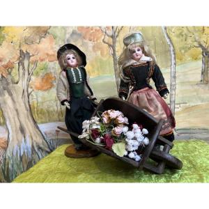 All Original Pair Of French Jumeau Fashion Dolls And Wheelbarrow
