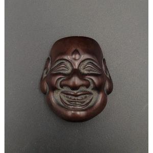 Netsuke - Hotei Mask With Urna - Deme Uman - Wood - Japan - 19th Century