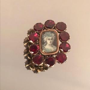 Brooch With Miniature Surrounded By Red Stones From The XIXth Century