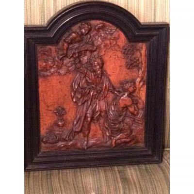 A Carved Wood Panel Representing A Religious Scene