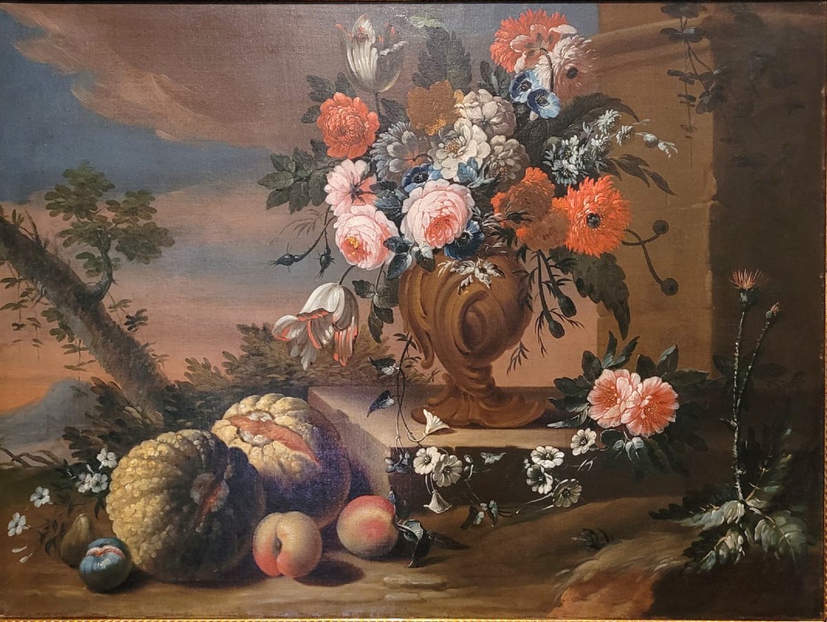 Natura morta con vaso di fiori, zucca e frutta in un paesaggio”-photo-2