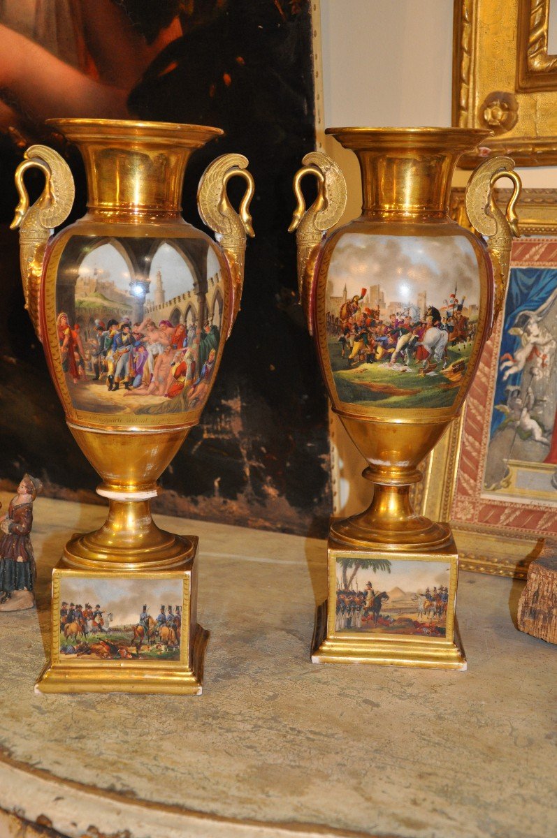 Coppia di vasi in porcellana policroma e dorata, raffiguranti episodi della vita di Napoleone.